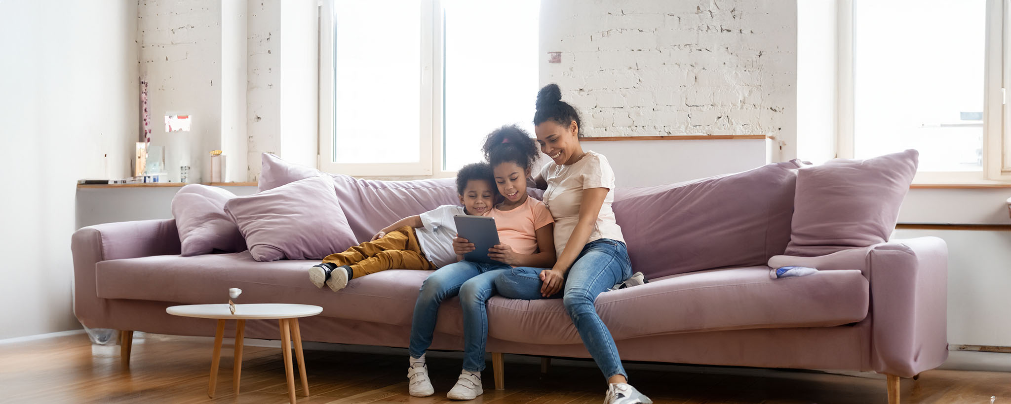 mother and children sit on couch making an emergency plan. 