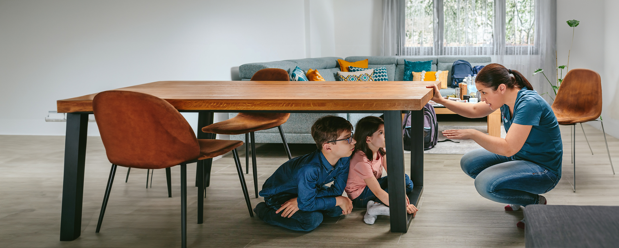 mother teaching kids how to do an earthquake drill