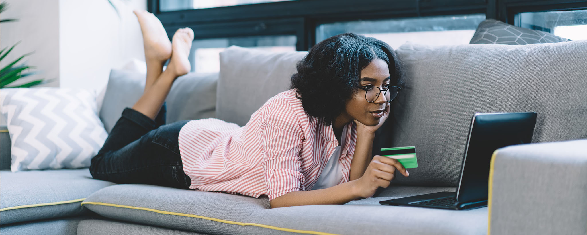 woman on her laptop making a purchase with her credit card