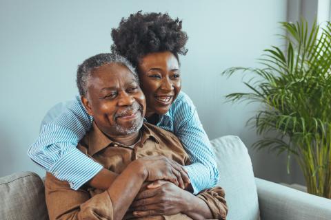 middle aged daughter with her older father. 